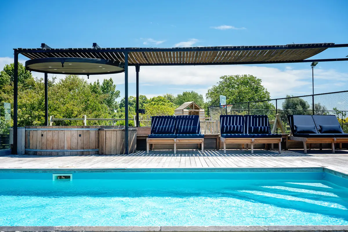 Saltwater pool with sun loungers and hot tub at Lawn Road Retreat, Hawke's Bay