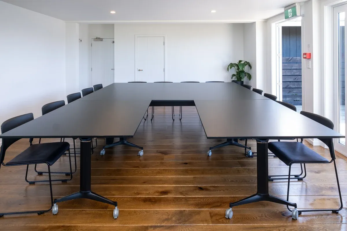 Meeting room set up with a large U-shaped table and chairs at Lawn Road Retreat
