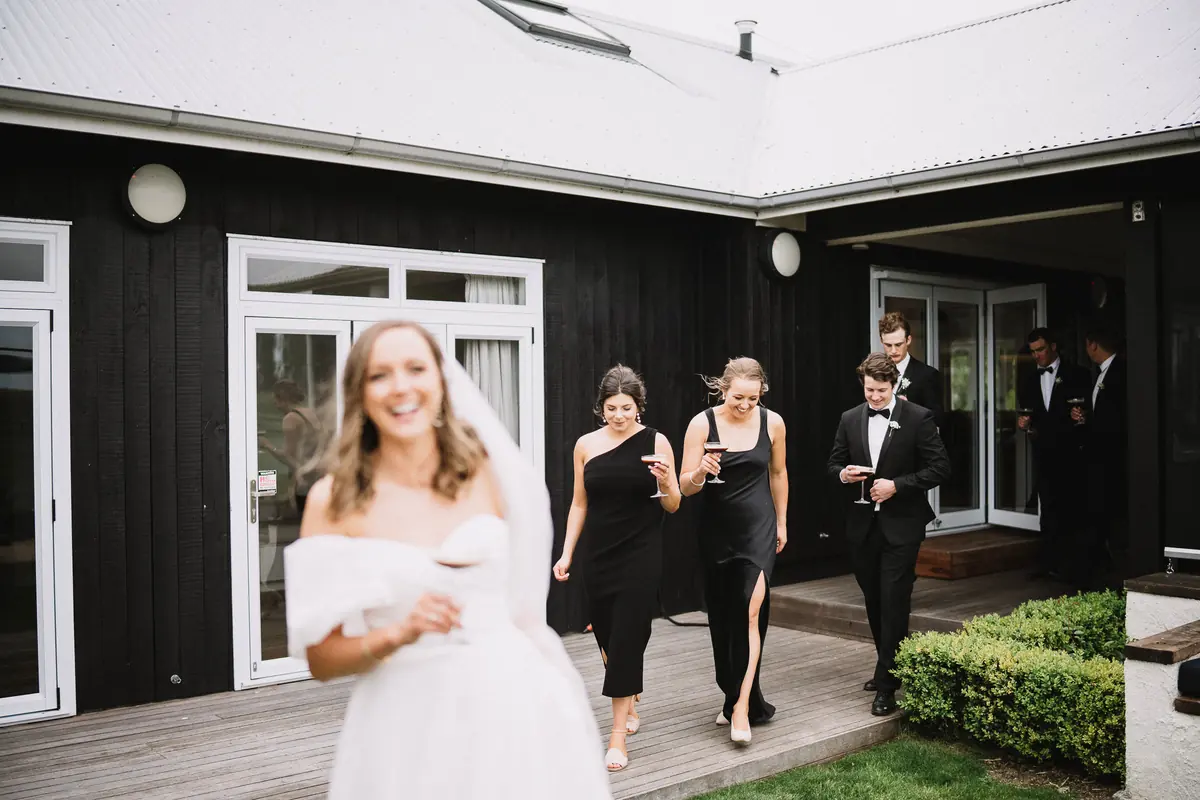 Wedding party stepping out of Lawn Road Retreat, Hawke's Bay