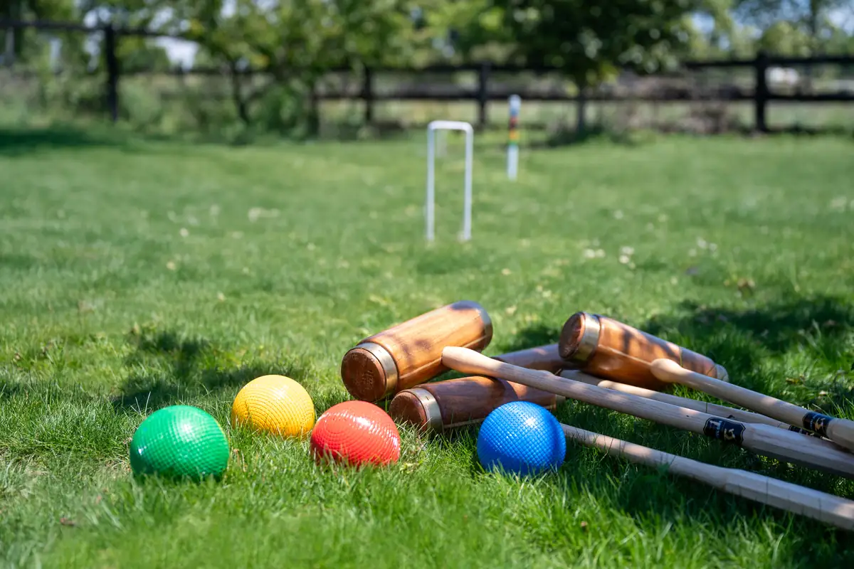 Croquet mallets and balls set out on the lawn at Lawn Road Retreat