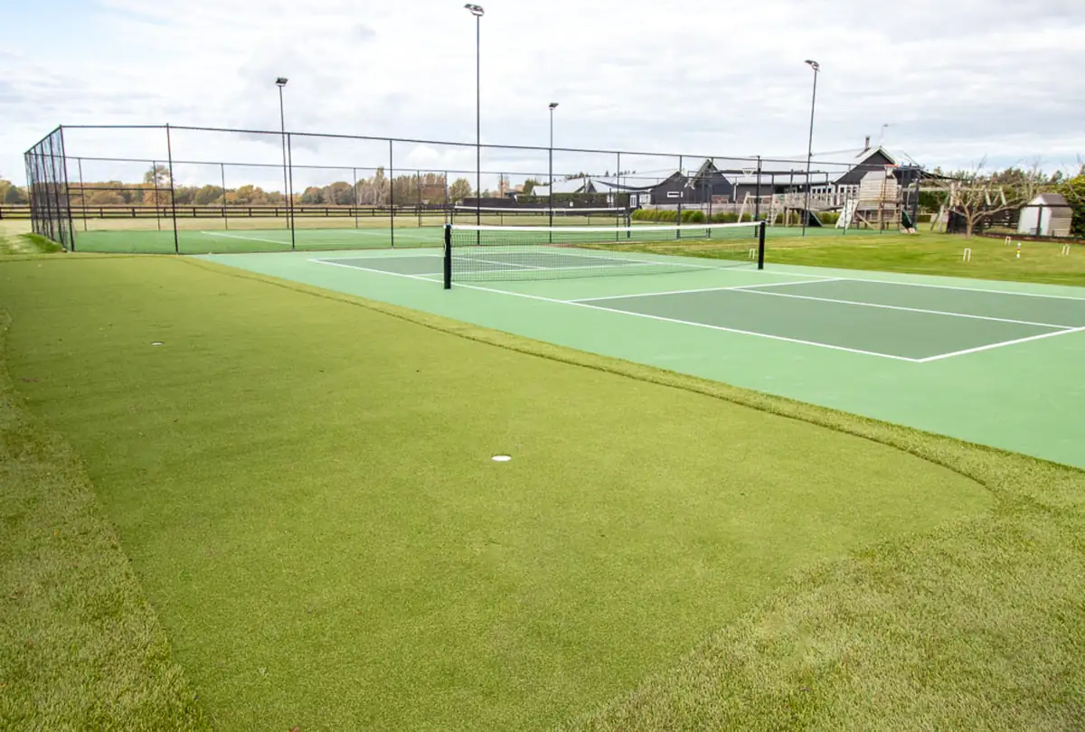 Tennis and pickleball courts with putting green and farmland views at Lawn Road Retreat, Hawke's Bay